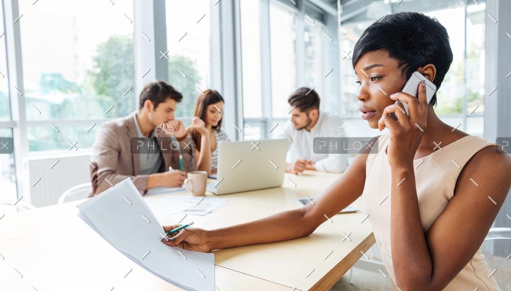 serious-businesswoman-with-documents-talking-on-P9Q6LX6